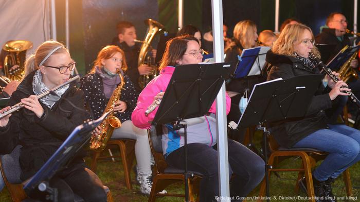 A brass band plays in a tent