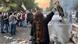 A woman lifts her headscarf in the air during a protest in September 2022 A woman lifts her headscarf in the air during a protest in September 2022