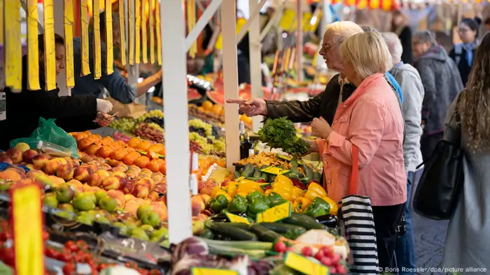 Shoppers at an outdoor food market in Frankfurt in fall