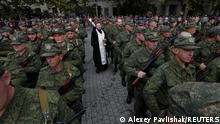 27.09.2022****An Orthodox priest conducts a service for reservists drafted as part of the partial mobilisation, during a ceremony of their departure for military bases, in Sevastopol, Crimea September 27, 2022. REUTERS/Alexey Pavlishak TPX IMAGES OF THE DAY 