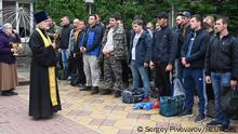 An Orthodox priest conducts a service for reservists drafted during partial mobilisation, before their departure for military bases, in the city of Bataysk in the Rostov region, Russia September 26, 2022. REUTERS/Sergey Pivovarov