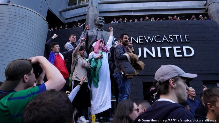 Newcastle United fans celebrate at St James' Park following the announcement that The Saudi-led takeover of Newcastle has been approved. 