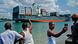 Men watching a container ship sail through the port of Dar es Salaam Men watching a container ship sail through the port of Dar es Salaam