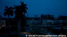 A neighborhood sits dark during a blackout triggered by the passing of Hurricane Ian in Havana, Cuba, early morning Wednesday, Sept. 28, 2022. Hurricane Ian knocked out electricity to the entire island when it hit the island’s western tip as a major storm. (AP Photo/Ismael Francisco)