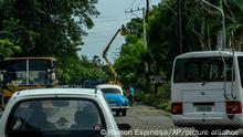 Operators from the electric company mounted on a crane try to repair broken power lines in the wake of Hurricane Ian in Havana, Cuba, Wednesday, Sept. 28, 2022. Cuba remained in the dark early Wednesday after Ian knocked out its power grid and devastated some of the country's most important tobacco farms when it hit the island's western tip as a major storm. (AP Photo/Ramon Espinosa)