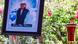 A framed image of Tomas Roho next to the coffin with his remains. A framed image of Tomas Roho next to the coffin with his remains.