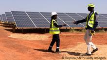 Technicians walk through solar panels on October 22, 2016 during the opening ceremony of a new photovoltaic energy production site in Bokhol.
Senegal put into service one of sub-Saharan Africa's largest solar energy projects Saturday as it pushes to become a regional player in renewables on a continent where the majority remain off-grid. / AFP PHOTO / SEYLLOU (Photo credit should read SEYLLOU/AFP via Getty Images)