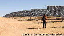 (220624) -- OMARURU (NAMIBIA), June 24, 2022 (Xinhua) -- A person stands in front of photovoltaic panels at a photovoltaic (PV) power plant in Omaruru, the Erongo region, Namibia, on June 24, 2022. Namibian state-owned utility, NamPower on Friday inaugurated the utility's first fully owned 20MW photovoltaic (PV) power plant at an event in Omaruru in the Erongo region. (Photo by Musa C Kaseke/Xinhua)