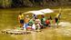 Tourists on a boat sailing along a river Tourists on a boat sailing along a river