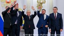 From left, Moscow-appointed head of Kherson Region Vladimir Saldo, Moscow-appointed head of Zaporizhzhia region Yevgeny Balitsky, Russian President Vladimir Putin, center, Denis Pushilin, the leader of the Donetsk People's Republic and Leonid Pasechnik, leader of self-proclaimed Luhansk People's Republic wave during a ceremony to sign the treaties for four regions of Ukraine to join Russia, at the Kremlin in Moscow, Friday, Sept. 30, 2022. The signing of the treaties making the four regions part of Russia follows the completion of the Kremlin-orchestrated referendums. (Mikhail Metzel, Sputnik, Kremlin Pool Photo via AP)