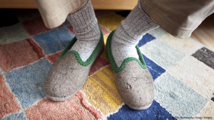 Feet in socks and slippers on a carpet Feet in socks and slippers on a carpet