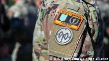 August 8, 2022 - Grafenwoehr, Bayern, Germany - A U.S. Army Soldier assigned to Task Force Orion, 27th Infantry Brigade Combat Team, New York Army National Guard, wears the Combat Training Center-Yavoriv Advisor patch above the 27th IBCT patch during the Joint Multinational Training Group-Ukraine Transfer of Authority ceremony in Grafenwoehr, Germany, August 8, 2022. Task Force Orion assumed the JMTG-U mission from Task Force Gator, 53rd IBCT, Florida Army National Guard, and will continue to ensure the combat effectiveness of Ukrainian military personnel training on systems and equipment issued under the United Statesâ Presidential Drawdown Authority. (Credit Image: © U.S. Army/ZUMA Press Wire Service/ZUMAPRESS.com