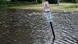 A sign warns against parking on grass in South Carolina as waters from Hurricane Ian covers a footpath around a pond, as well as grassy areas and the root systems of Spanish moss-covered trees A sign warns against parking on grass in South Carolina as waters from Hurricane Ian covers a footpath around a pond, as well as grassy areas and the root systems of Spanish moss-covered trees