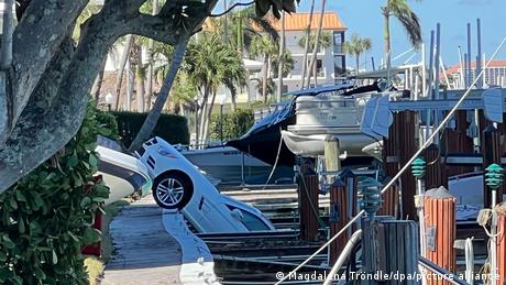 A car hangs half out of a marina in Moorings Bay, Naples, Florida