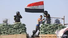 BAGHDAD, IRAQ - OCTOBER 01: Security forces block the Republic Bridge leading to the Green Zone with concrete barriers as hundreds of Iraqis hold banners and shout slogans as they gather for a demonstration demanding justice for demonstrators killed during the 2019 revolt dubbed the October Revolution, at the Tahrir Square in Baghdad, Iraq on October 01, 2022. Security forces closed the Republic Bridge leading to the Green Zone with concrete barriers. Murtadha Al-Sudani / Anadolu Agency