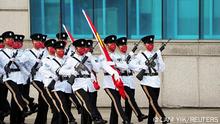 Police perform Chinese-style goose-step drill with Chinese and Hong Kong flags during a ceremony to mark the Chinese National Day in Hong Kong, China October 1, 2022. REUTERS/Lam Yik