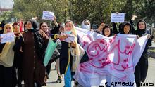 Afghan women display placards and chant slogans during a protest they call Stop Hazara genocide a day after a suicide bomb attack at Dasht-e-Barchi learning centre, in Kabul on October 1, 2022. - Dozens of women from Afghanistan's minority Hazara community protested in the capital October 1, after a suicide bombing a day earlier killed 20 people. (Photo by AFP) (Photo by -/AFP via Getty Images)
