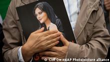 A portrait of Mahsa Amini is held during a rally calling for regime change in Iran following the death of Amini, a young woman who died after being arrested in Tehran by Iran's notorious morality police, in Washington, Saturday, Oct. 1, 2022. (AP Photo/Cliff Owen)