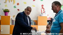 The head of GERB party and former Bulgaria's prime minister Boyko Borisov (L) casts his ballot at a polling station during the country's parliamentary elections in Sofia on October 2, 2022. - Bulgarians began voting in their fourth general election in 18 months, anxious about soaring consumer prices and energy costs ahead of a winter overshadowed by the Ukraine war. (Photo by Nikolay DOYCHINOV / AFP) (Photo by NIKOLAY DOYCHINOV/AFP via Getty Images)