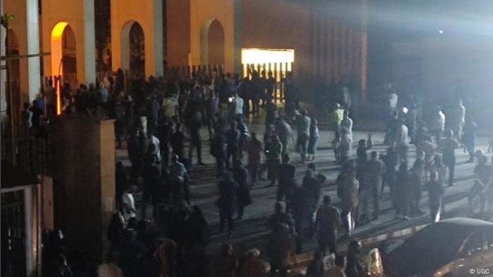 People gather in front of the university building