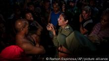 A government official speaks to demonstrators during a protest calling for the restoration of electrical service after six days of blackouts due to the devastation of Hurricane Ian in Havana, Cuba, Saturday, Oct 1, 2022. (AP Photo/Ramon Espinosa)
