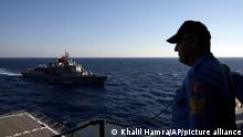A Turkish officer looks at a naval ship during an annual NATO naval exercise on Turkey's western coast on the Mediterranean, Thursday, Sept. 15, 2022. Having spent recent months engaged in an escalating war of words over disputes in the Aegean and Mediterranean Seas, Turkey and Greece came together for an annual NATO naval exercise on Tuesday. The traditional rivals are among 12 alliance members taking part in Dynamic Mariner-Mavi Balina 22 off Turkey's western coast. (AP Photo/Khalil Hamra)