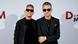 Depeche Mode's Martin Gore and Dave Gahan wearing sunglasses, all in black. Depeche Mode's Martin Gore and Dave Gahan wearing sunglasses, all in black.