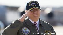 US President Donald Trump salutes as he walks to Air Force One prior to departing from Langley Air Force Base in Virginia, March 2, 2017, as he traveled to Newport News, Virginia, to visit the pre-commissioned USS Gerald R. Ford aircraft carrier. (Photo by SAUL LOEB / AFP) (Photo credit should read SAUL LOEB/AFP via Getty Images)