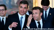 Spain's Prime Minister Pedro Sanchez, left, talks to French President Emmanuel Macron after a family picture before a dinner hosted by Spain's King Felipe VI and Spain's Queen Letizia at the Royal Palace in Madrid, Tuesday, June 28, 2022. North Atlantic Treaty Organization heads of state will meet for a NATO summit in Madrid from Tuesday through Thursday. (Bertrand Guay; Pool via AP)