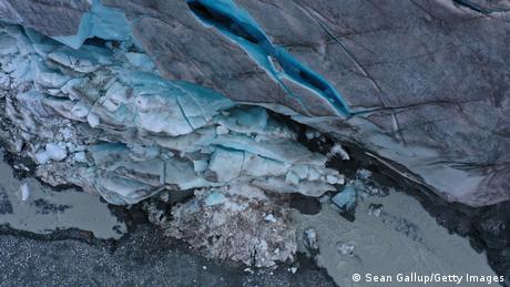 In this aerial view, ice breaks off the receding Findel glacier at a stream of the glacier's meltwater on June 22, 2022 near Zermatt, Switzerland.