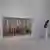 Blick in einen Ausstellungsraum der Pinakothek mit dem Gemälde "Vier Elemente" an der Wand und einer schwarzen Skulptur daneben. 