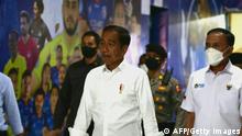 Indonesias President Joko Widodo (C) and Indonesia's Football Association of Indonesia (PSSI) chief Mochamad Iriawan (R) visit the Kanjuruhan stadium following a stampede that killed at least 131 people, in Malang, East Java on October 5, 2022. - Widodo said on October 5 that he would order an audit of all football stadiums in the country, vowing to find the root cause of one of the deadliest disasters in the sport's history. (Photo by AFP) (Photo by STR/AFP via Getty Images)