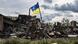 Ukrainian flag waves in a residential area heavily damaged in the village of Dolyna in Donetsk Oblast Ukrainian flag waves in a residential area heavily damaged in the village of Dolyna in Donetsk Oblast