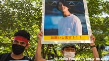 A group of activists hold placards of Japanese citizen Toru Kubota, who is detained in Myanmar, during a rally in front of the Ministry of Foreign Affairs in Tokyo