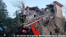 In this photo provided by the Ukrainian Emergency Service, rescuers work at the scene of a building damaged by shelling in Zaporizhzhia, Ukraine, Thursday, Oct. 6, 2022. (Ukrainian Emergency Service via AP)