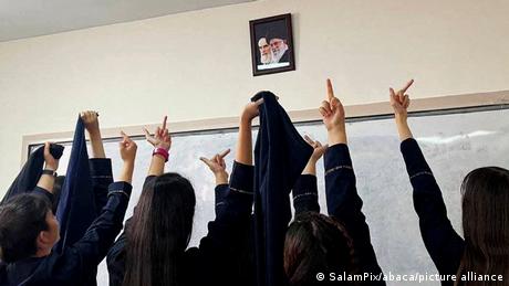 Students in one of the girls' high schools joined the nationwide anti-government demonstrations after the death of Mahsa Amini in Iran, giving the middle finger to a picture of Ayatollah Ruhollah Khomeini, the nation's founder, and Ali Khamenei, the leader of the Islamic Republic of Iran, chanting the slogan Death to the dictator.