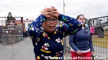 A woman cries as she waits for news of her loved one after a deadly prison riot in Latacunga, Ecuador, Tuesday, Oct. 4, 2022. A clash between inmates armed with guns and knives inside the prison has left at least 15 people dead and 20 injured. (AP Photo/Dolores Ochoa)