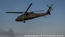 A helicopter takes off from a US military base at an undisclosed location in eastern Syria, Monday, Nov. 11, 2019. The deployment of the mechanized force comes after US troops withdrew from northeastern Syria, making way for a Turkish offensive that began last month. (AP Photo/Darko Bandic)