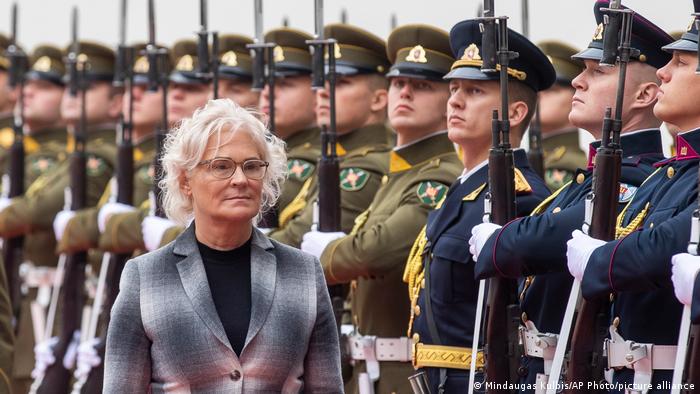 German Defense Minister Christine Lambrecht walks by a Lithuanian guard of honor