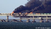 TOPSHOT - Black smoke billows from a fire on the Kerch bridge that links Crimea to Russia, after a truck exploded, near Kerch, on October 8, 2022. - Moscow announced on October 8, 2022 that a truck exploded igniting a huge fire and damaging the key Kerch bridge -- built as Russia's sole land link with annexed Crimea -- and vowed to find the perpetrators, without immediately blaming Ukraine. (Photo by AFP) (Photo by -/AFP via Getty Images)
