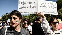 Iranians living in Greece hold placards as they take part in a demonstration, following the death in Tehran of an Iranian woman after her arrest by the country's morality police, in Thessaloniki on October 8, 2022. - Mahsa Amini, 22, was on a visit with her family to the Iranian capital Tehran, when she was detained on September 13, 2022, by the police unit responsible for enforcing Iran's strict dress code for women, including the wearing of the headscarf in public. (Photo by Sakis MITROLIDIS / AFP)