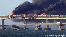 08/10/2022***
Black smoke billows from a fire on the Kerch bridge that links Crimea to Russia, after a truck exploded, near Kerch, on October 8, 2022. - Moscow announced on October 8, 2022 that a truck exploded igniting a huge fire and damaging the key Kerch bridge -- built as Russia's sole land link with annexed Crimea -- and vowed to find the perpetrators, without immediately blaming Ukraine. (Photo by AFP) (Photo by -/AFP via Getty Images)