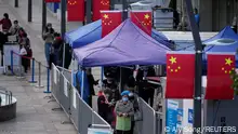 People line up to get tested for the coronavirus disease (COVID-19) at a nucleic acid testing site, following the coronavirus disease (COVID-19) outbreak, in Shanghai, China, October 10, 2022. REUTERS/Aly Song