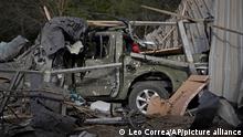 A damaged car is seen under the debris of a car shop that was destroyed after a Russian attack in Zaporizhzhia, Ukraine, Tuesday, Oct. 11, 2022. (AP Photo/Leo Correa)