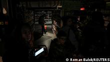 People visit a grocery store without electricity in the city centre, after a Russian missile attack in Lviv, Ukraine October 11, 2022. REUTERS/Roman Baluk