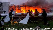 Firefighters work at the site of a car retailer office building, destroyed during a Russian missile attack in Zaporizhzhia, Ukraine October 11, 2022. Press service of the State Emergency Service of Ukraine/Handout via REUTERS ATTENTION EDITORS - THIS IMAGE HAS BEEN SUPPLIED BY A THIRD PARTY. DO NOT OBSCURE LOGO.
