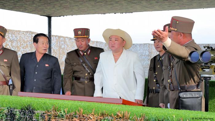 North Korean leader Kim Jong Un oversees military drills alongside officials