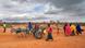 A group of adults and children and a donkey cart A group of adults and children and a donkey cart