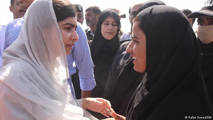 Malala Yousufzai speaks with a group of flood victims in Pakistan's southern Sindh province