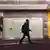 A man walks past a closed shop in Bonn, Germany